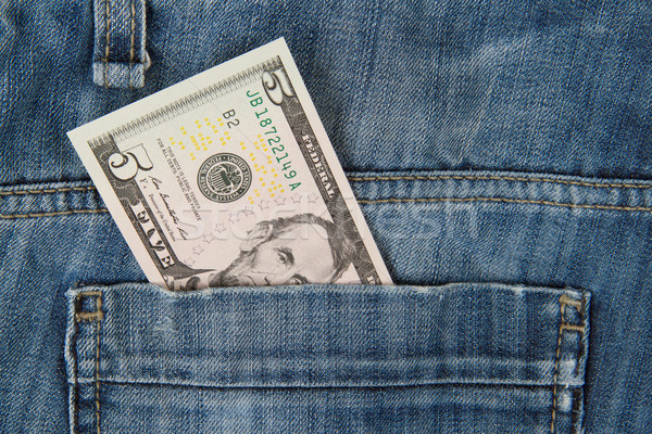 Macro shot of trendy jeans with american 5 dollar bill Stock photo © michaklootwijk