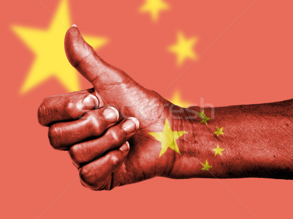 Old woman with arthritis giving the thumbs up sign, wrapped in f Stock photo © michaklootwijk