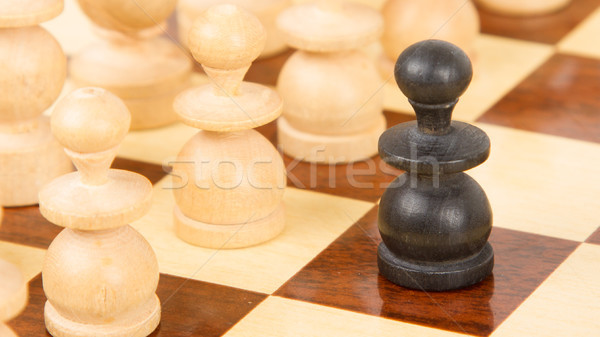 Black pawn on a wooden chessboard Stock photo © michaklootwijk