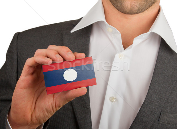 üzletember tart névjegy Laosz zászló munkás Stock fotó © michaklootwijk