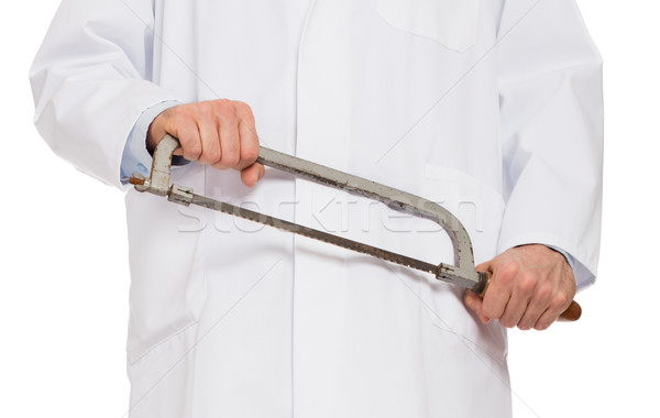 Crazy doctor is holding a big saw in his hands Stock photo © michaklootwijk