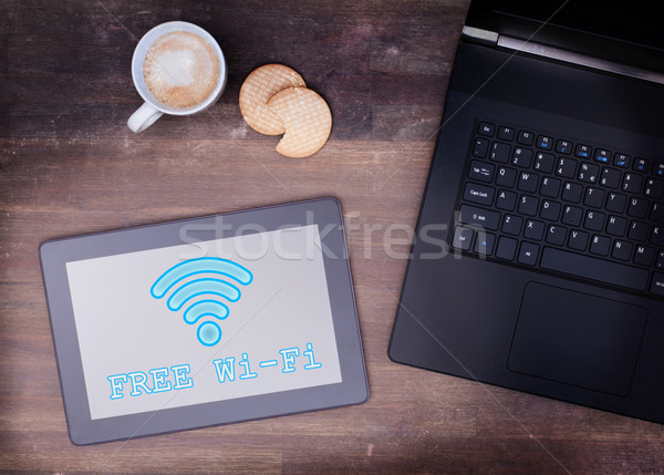 Tablet with Wi-Fi connection on a wooden desk Stock photo © michaklootwijk