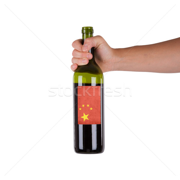 Kéz tart üveg vörösbor címke Kína Stock fotó © michaklootwijk
