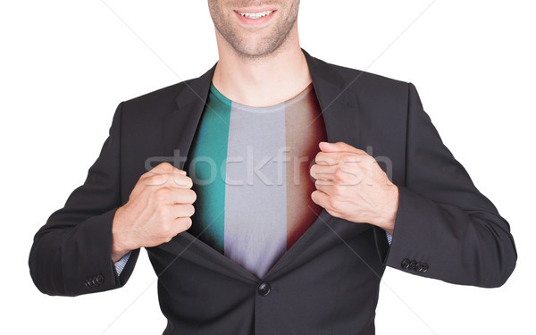 Businessman opening suit to reveal shirt with flag Stock photo © michaklootwijk