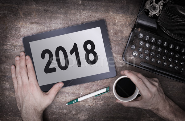 Tablet touch computer gadget on wooden table - 2018 Stock photo © michaklootwijk