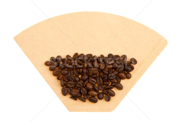 Stock photo: Coffee beans on a coffee filter (white background)