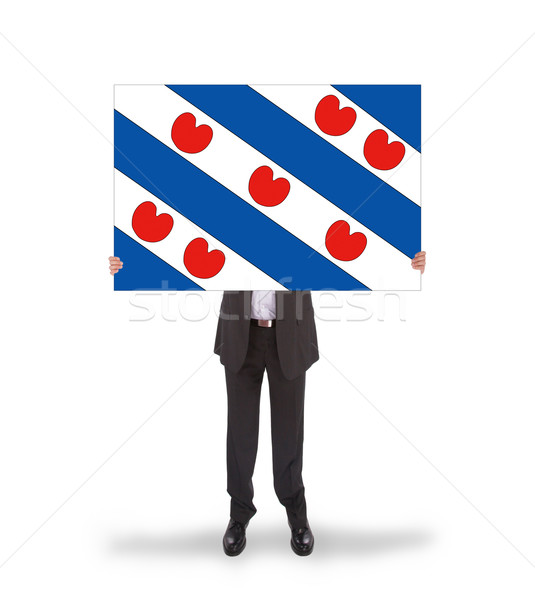 Smiling businessman holding a big card, flag of the dutch provin Stock photo © michaklootwijk