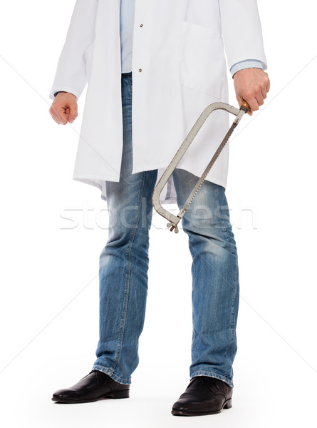 Crazy doctor is holding a big saw in his hands Stock photo © michaklootwijk