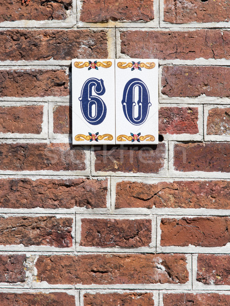 House number on a red brick wall in the Netherlands Stock photo © michaklootwijk