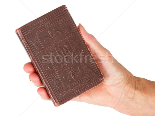 Old hand (woman) holding a very old bible Stock photo © michaklootwijk