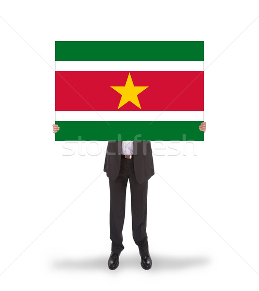 Businessman holding a big card, flag of Suriname Stock photo © michaklootwijk