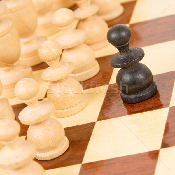 Black pawn on a wooden chessboard Stock photo © michaklootwijk