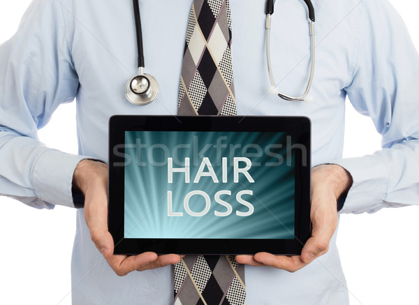 Doctor holding tablet - Hair loss Stock photo © michaklootwijk