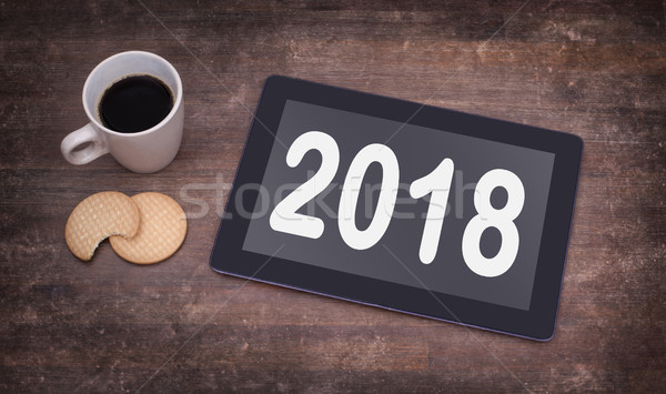 Tablet touch computer gadget on wooden table - 2018 Stock photo © michaklootwijk