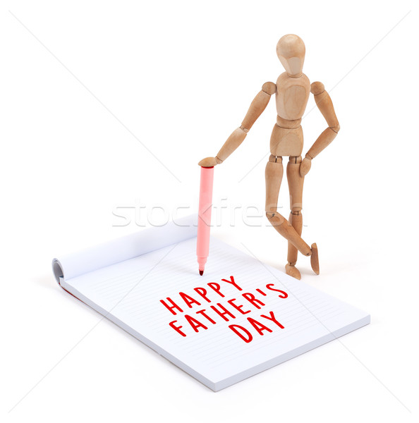 Wooden mannequin writing in scrapbook - Happy fathers day Stock photo © michaklootwijk