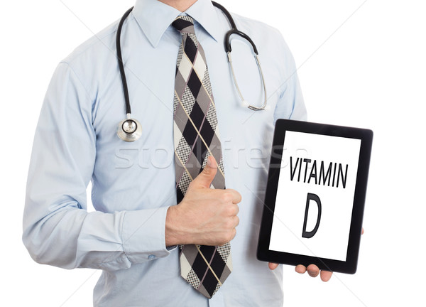 Stock photo: Doctor holding tablet - Vitamin D