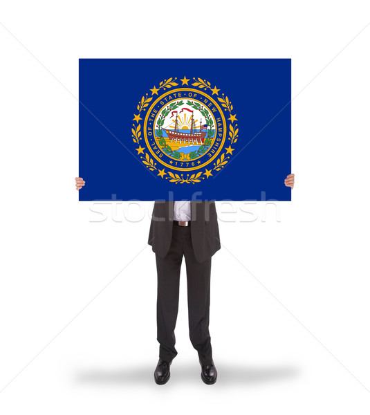 Smiling businessman holding a big card, flag of New Hampshire Stock photo © michaklootwijk