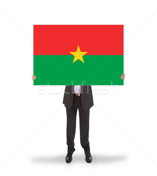 Businessman holding a big card, flag of Burkina Faso Stock photo © michaklootwijk