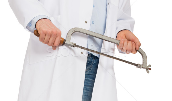 Crazy doctor is holding a big saw in his hands Stock photo © michaklootwijk