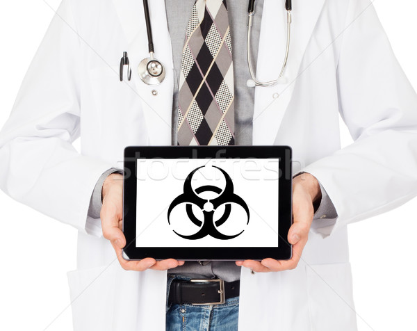 Doctor holding tablet - Warning! Biohazard! Stock photo © michaklootwijk