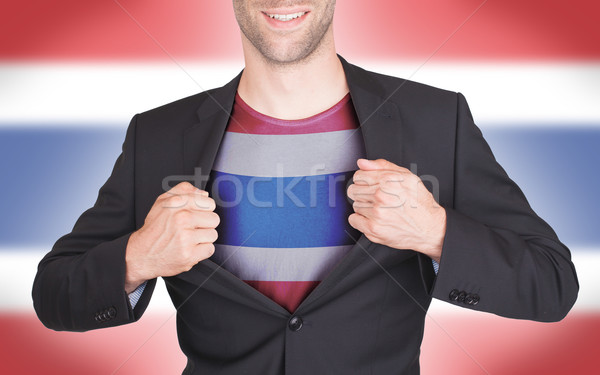 Stock photo: Businessman opening suit to reveal shirt with flag