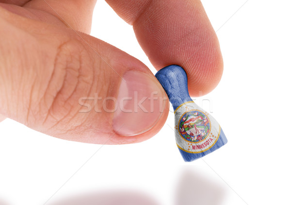 Hand holding wooden pawn, flag painting, selective focus Stock photo © michaklootwijk