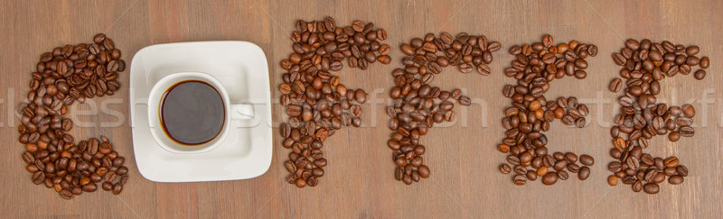 The word Coffee spelled with hundreds of coffee beans and one cu Stock photo © michaklootwijk