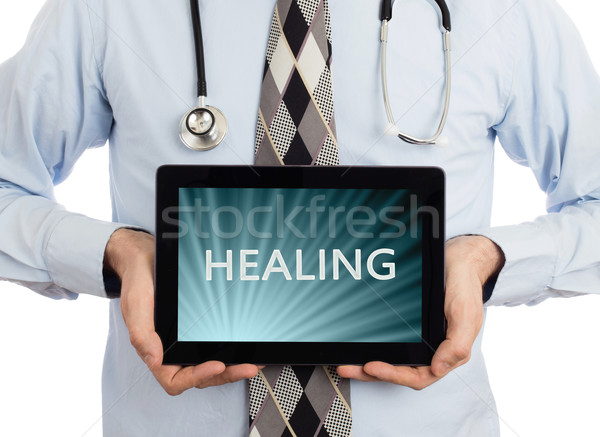 Arzt halten Tablet Heilung isoliert weiß Stock foto © michaklootwijk