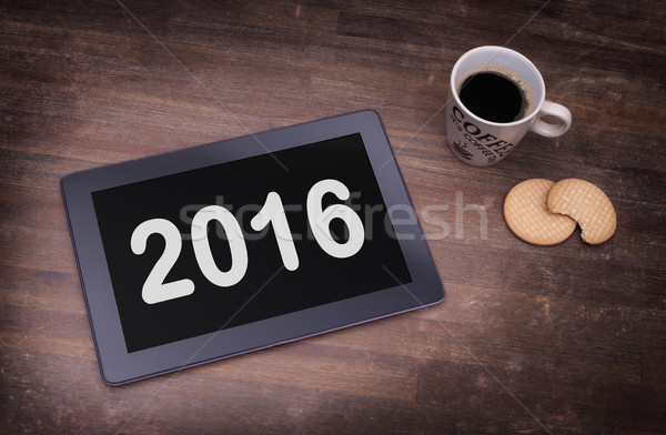 Tablet touch computer gadget on wooden table - 2016 Stock photo © michaklootwijk