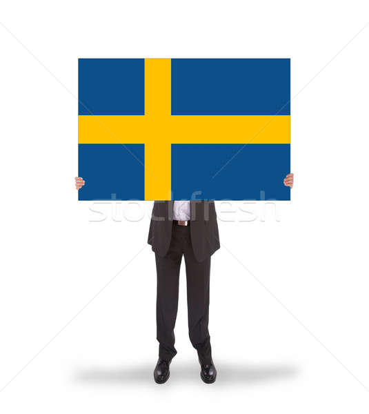 Smiling businessman holding a big card, flag of Sweden Stock photo © michaklootwijk