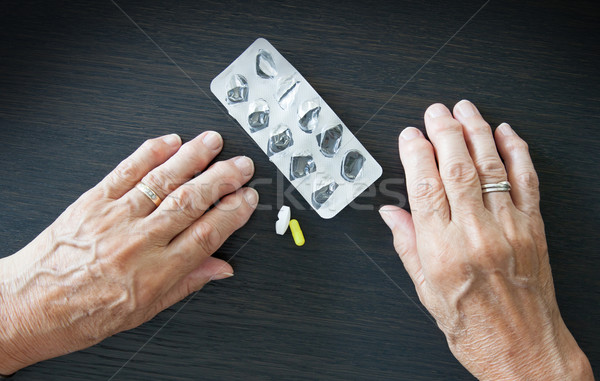 Elderly person taking medication Stock photo © michaklootwijk