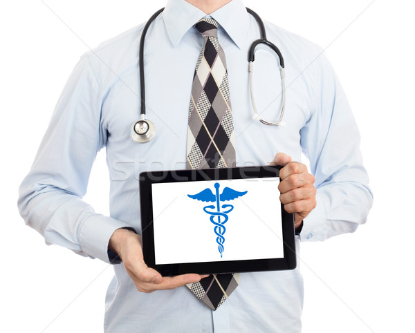 Doctor holding tablet - Caduceus symbol Stock photo © michaklootwijk