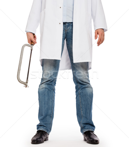 Crazy doctor is holding a big saw in his hands Stock photo © michaklootwijk