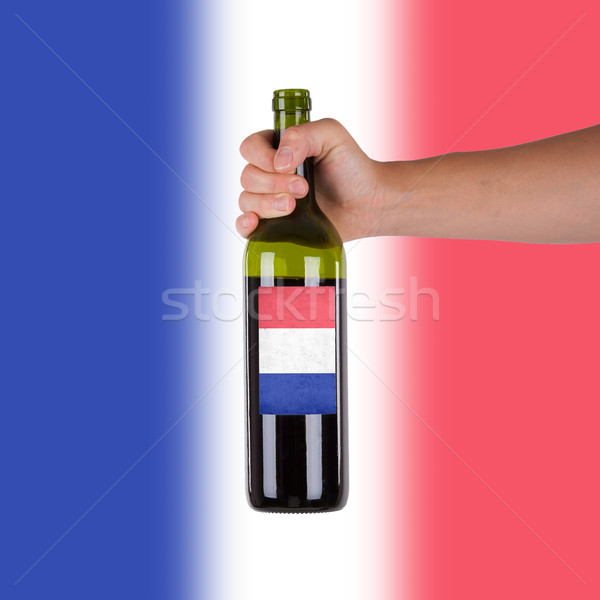 Mano bottiglia vino rosso etichetta Francia Foto d'archivio © michaklootwijk