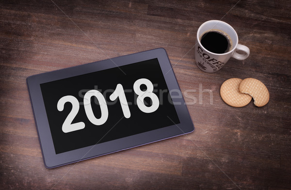 Tablet touch computer gadget on wooden table - 2018 Stock photo © michaklootwijk