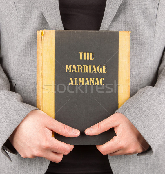 Woman holding a marriage almanac Stock photo © michaklootwijk