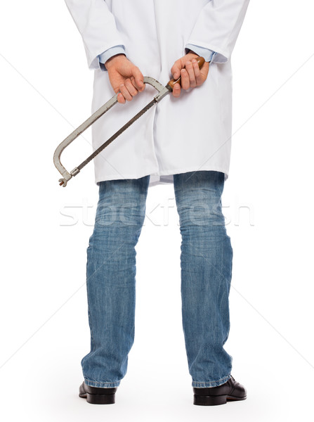 Crazy doctor is holding a big saw in his hands Stock photo © michaklootwijk