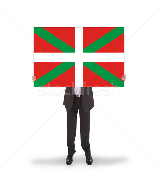 Smiling businessman holding a big card, flag of Basque Country Stock photo © michaklootwijk