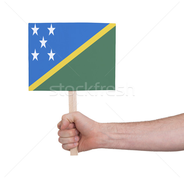 Hand holding small card - Flag of Solomon Islands Stock photo © michaklootwijk