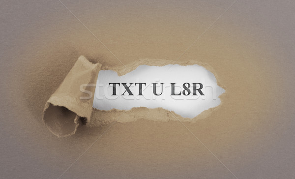 Text appearing behind torn brown envelop Stock photo © michaklootwijk