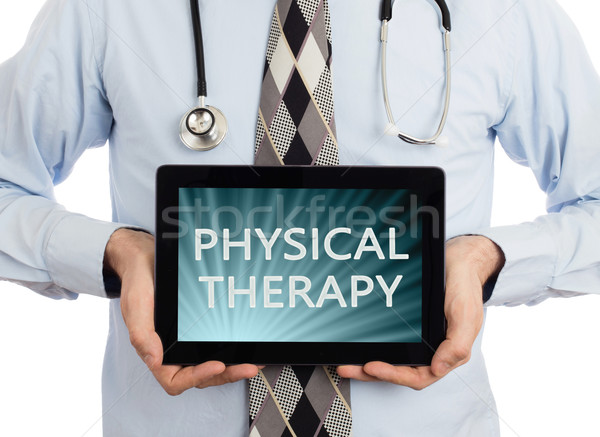 Stock photo: Doctor holding tablet - Physical therapy