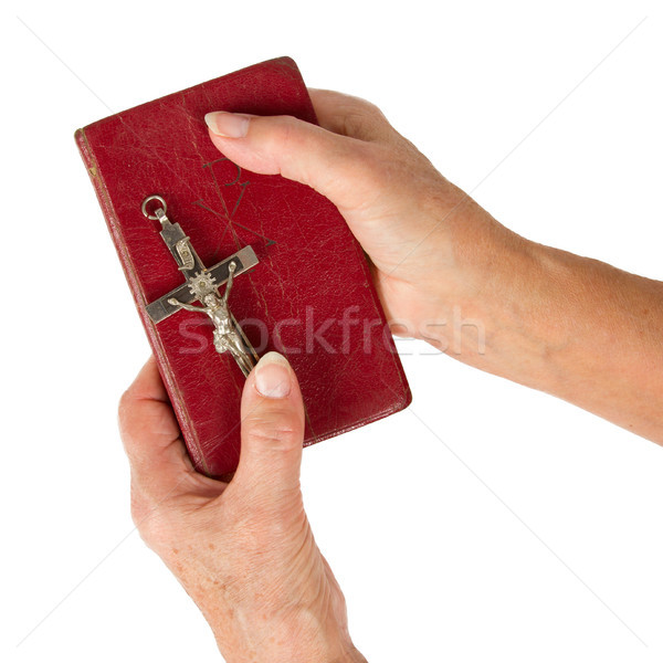 Stock photo: Old hands (woman) holding a very old bible