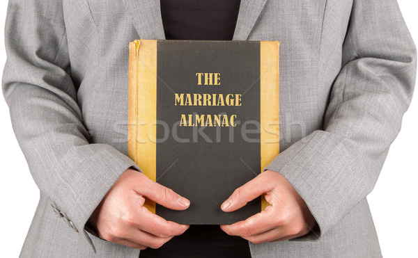 Woman holding a marriage almanac Stock photo © michaklootwijk