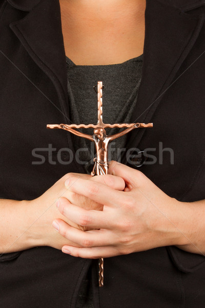 Woman in black with the cross in hands Stock photo © michaklootwijk