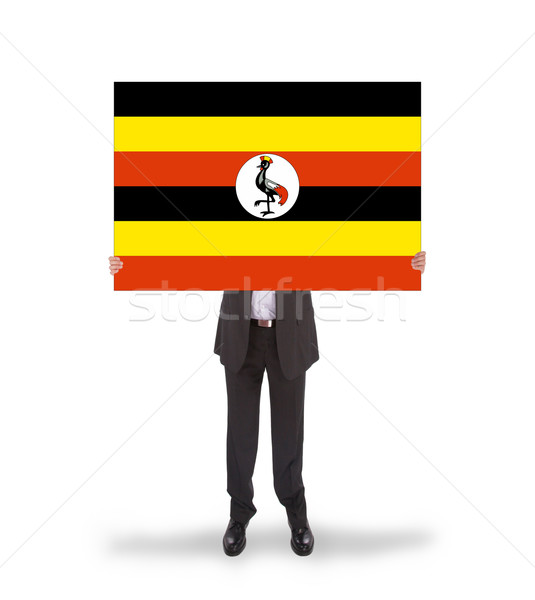 Businessman holding a big card, flag of Uganda Stock photo © michaklootwijk