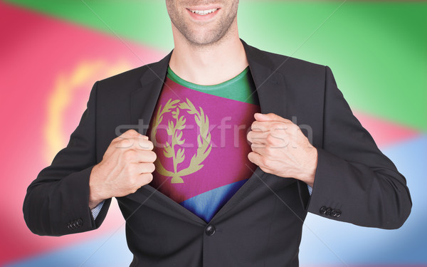 Businessman opening suit to reveal shirt with flag Stock photo © michaklootwijk