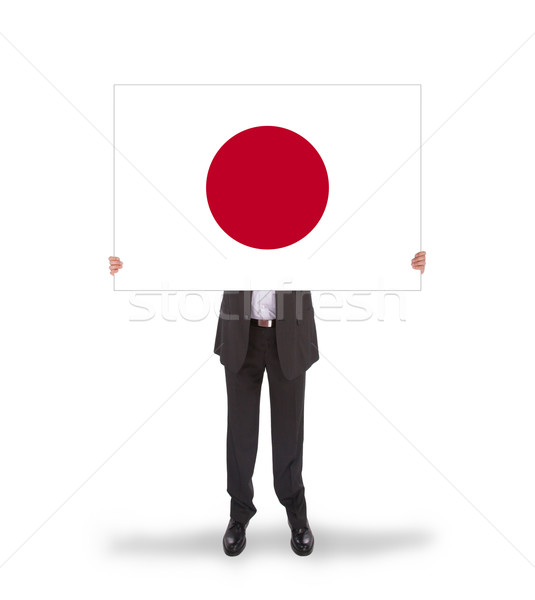 Businessman holding a big card, flag of Japan Stock photo © michaklootwijk