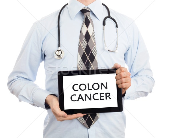Doctor holding tablet - Colon cancer Stock photo © michaklootwijk