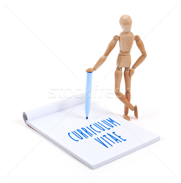 Wooden mannequin writing in scrapbook - Curriculum vitae Stock photo © michaklootwijk