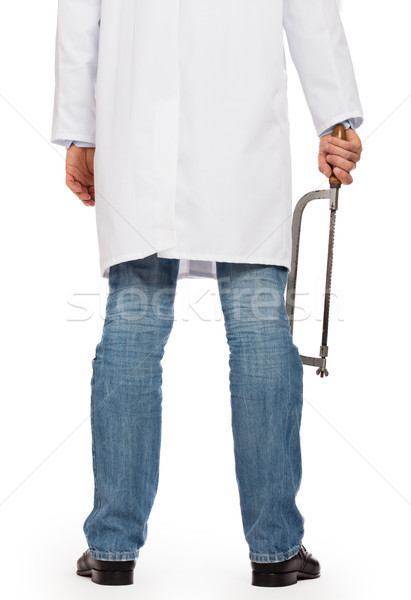 Crazy doctor is holding a big saw in his hands Stock photo © michaklootwijk